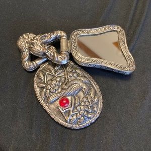 Silver metal small hand mirrors in an Eastern styled disign.